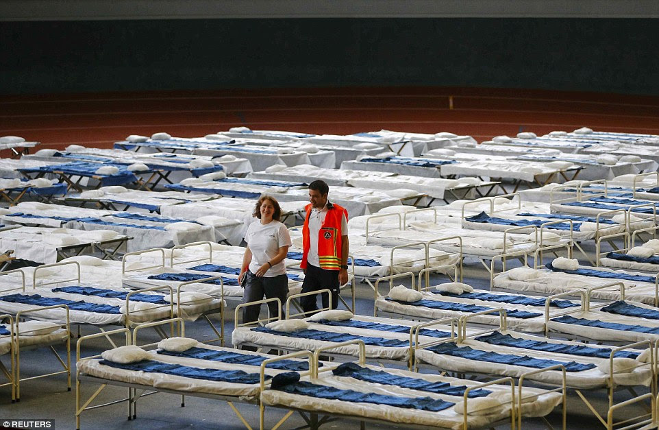 A makeshift bedroom is prepared for migrants at a sports hall in Hanau, Germany. Refugees will continue to arrive in Germany despite the government's introduction of temporary border controls