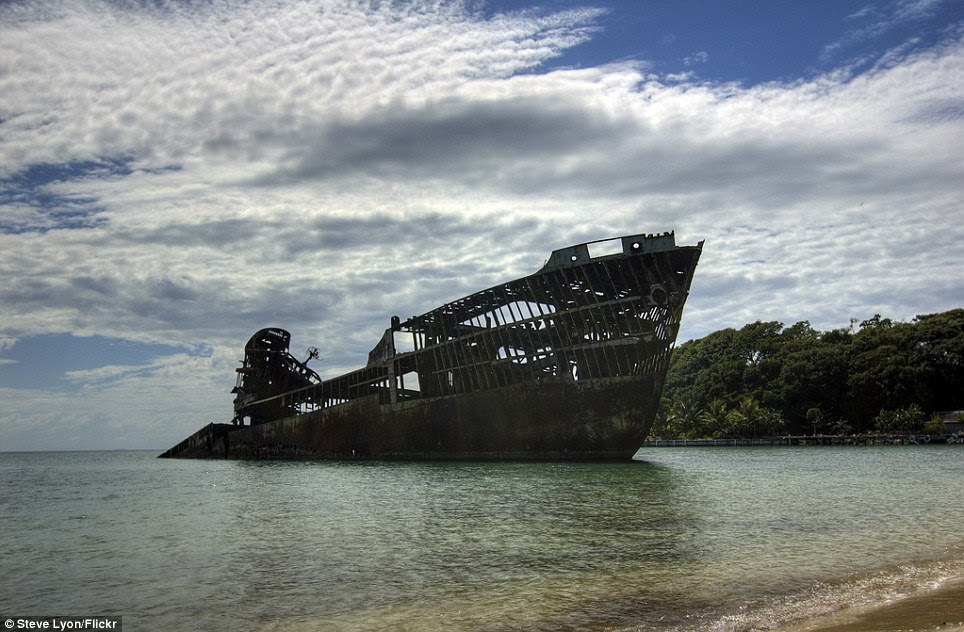 Naval carcass: The skeletal remains of this wreckage rise from the surf on the small island of Roatán, Islas de la Bahía, Honduras