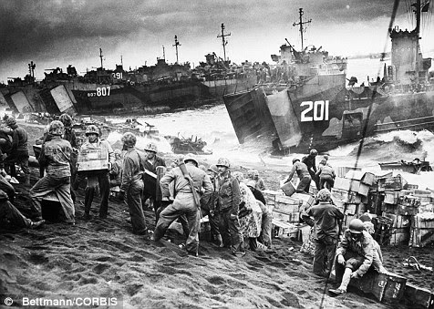 Navy landing craft disgorge tons of supplies onto the shores of Iwo Jima a few hours after U.S. Marines established a beach-head in March 1945