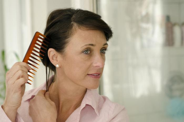 A woman combing her hair