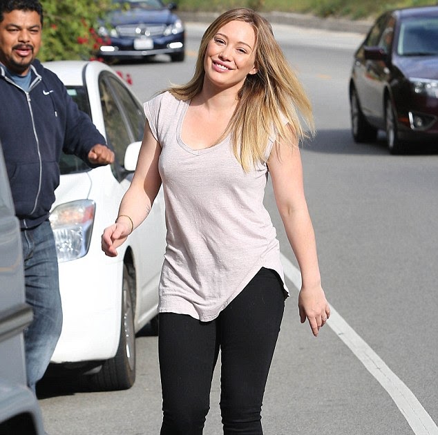 Hilary Duff shows off her gym honed body as she.