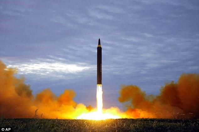 Pyongyang started moving a rocket towards the country's west coast on Monday, using the cover of darkness to avoid surveillance, South Korean media claim. Pictured: North Korea carried out a launch of an intermediate range missile in August