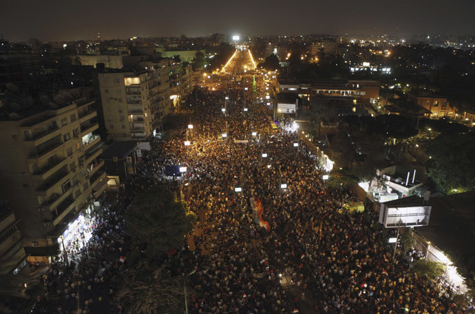 Protesters opposing Egyptian President Mohamed Morsi wave Egyptian flags and shout slogans against him and members of the Muslim Brotherhood, during a protest in front of El-Thadiya presidential palace in Cairo June 30, 2013. (Reuters)