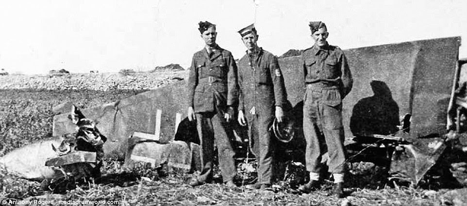Personnel of the three services stand at the crash site of a Junkers Ju 87, possibly a 2./Sturzkampfgeschwader machine, which was shot down at Hal Far in Malta on 18 January 1941