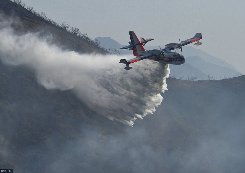 A Bombardier 415 Superscooper making a water drop on hot spots along the hillside east of Gibraltar Road