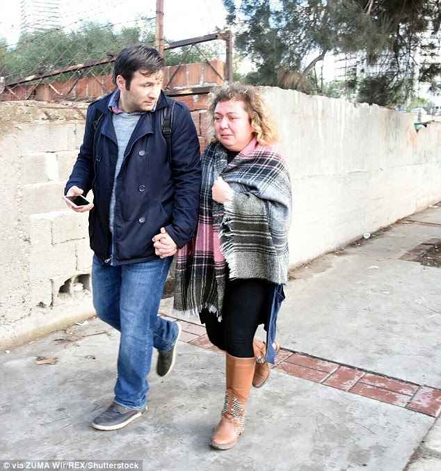 Aftermath: Shocked bystanders were seen in tears as they left the scene earlier today