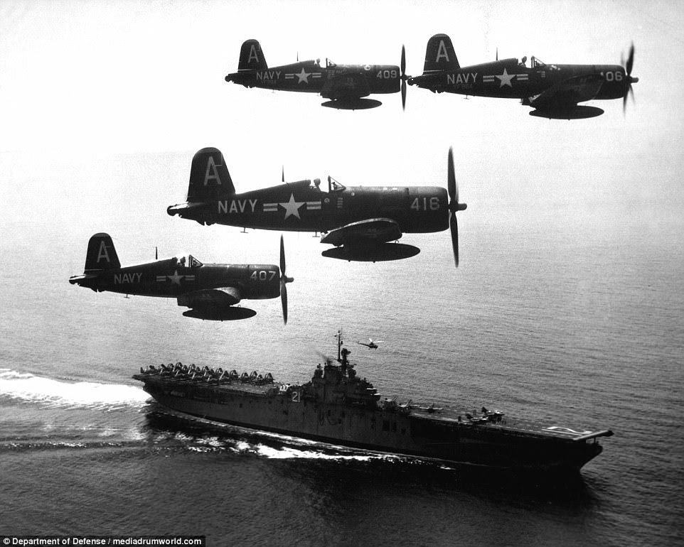Four US F4U's (Corsairs) returning from a combat mission over North Korea circling the USS Boxer as they wait for planes in the next strike to be launched from her flight deck in September 1951