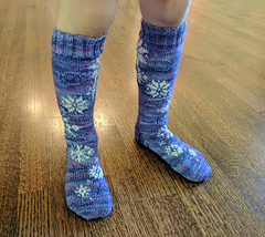 child wearing snowflake design socks