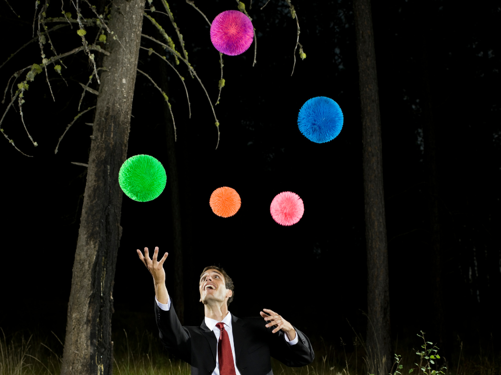 Man juggling colorful balls