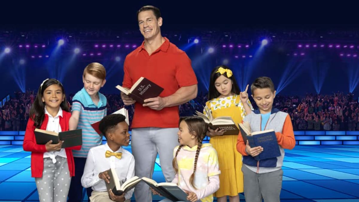 John Cena is posing with children on Are You Smarter Than A 5th Grader?.