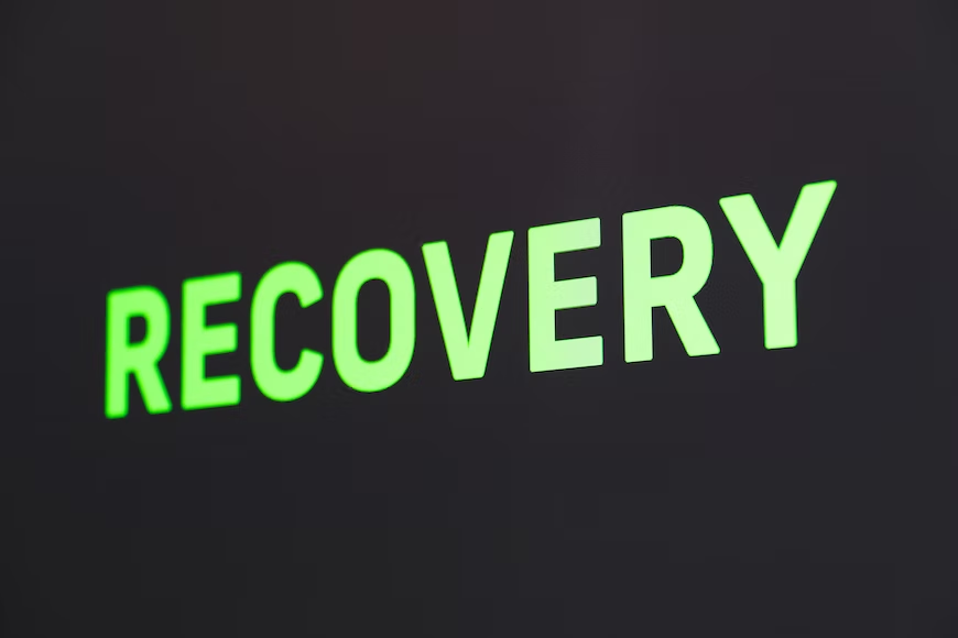 The word "Recovery" in green letters