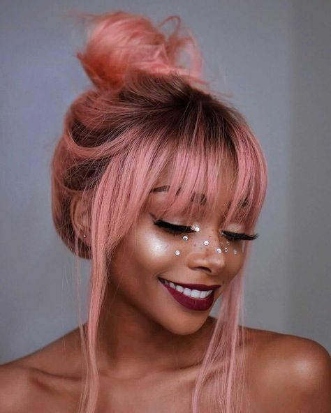 smiling lady wearing pink hair with fringe