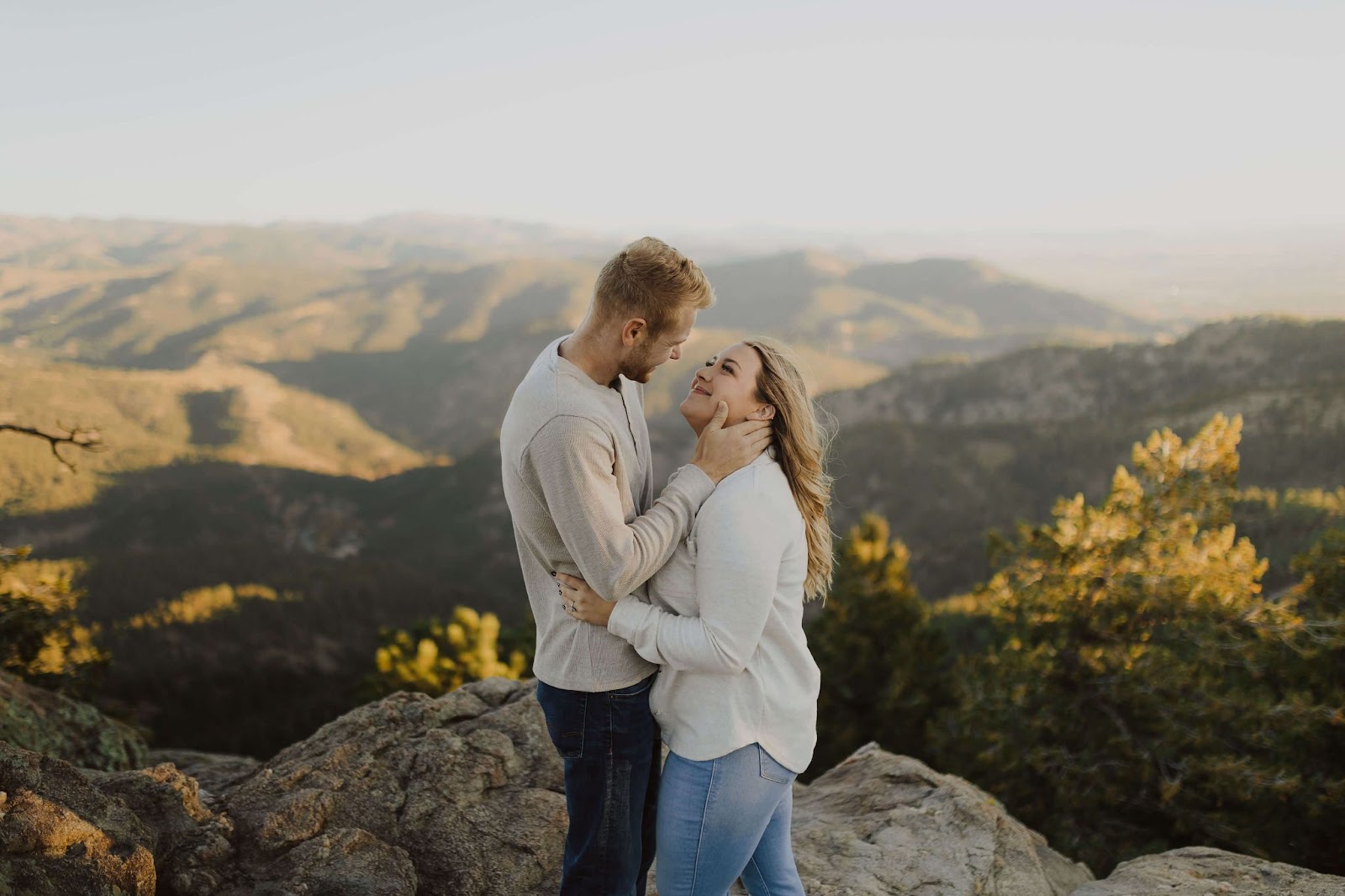 couple smiling at each other for engagement photos at Lost Gulch Overlook