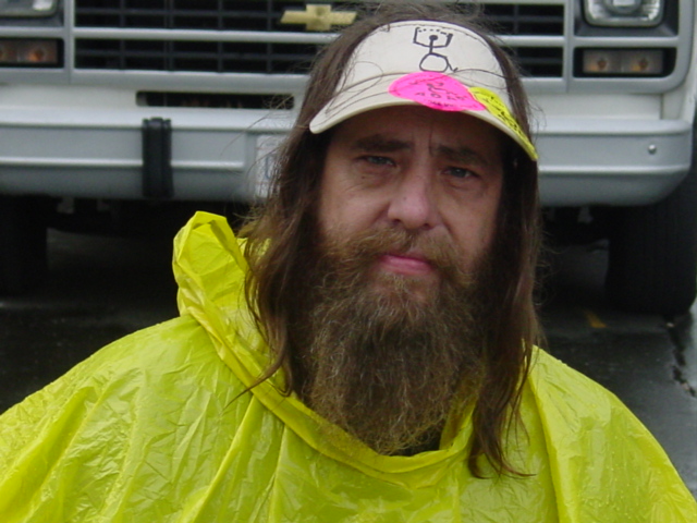 Man in rain gear and heavy beard.