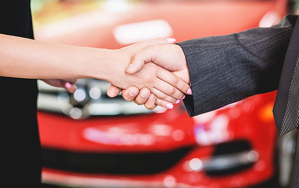 New Car vs Used Car Shaking Hands In Front Of Car, new car vs used car, advantages of new car, advantages of used car, disadvantages of used car, disadvantages of new car, should i buy old or new car, should i buy new or used car