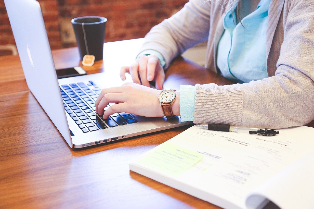 a man typing on a laptop