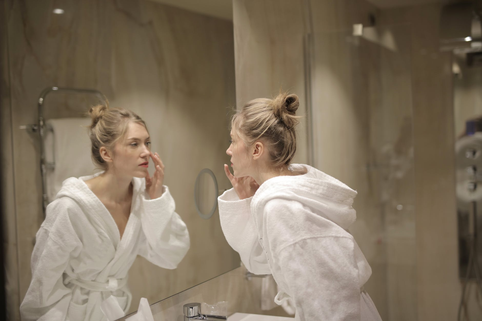 Woman checking herself out on the mirror.