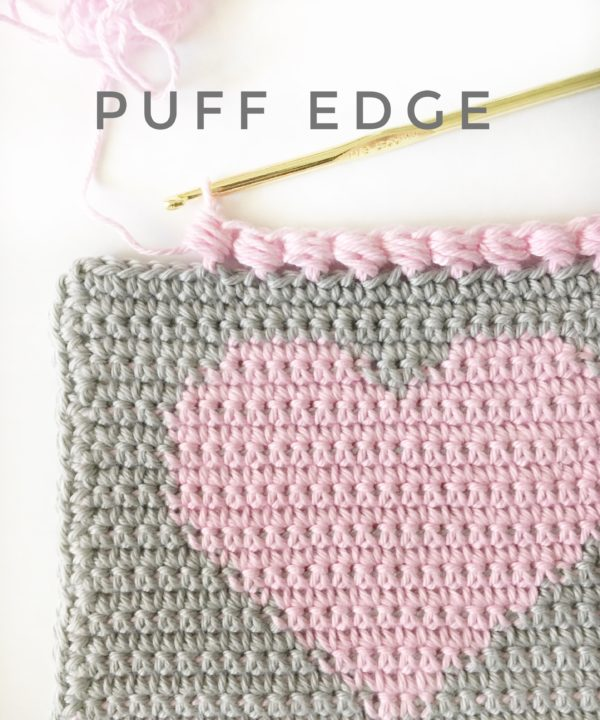 puff edge in pink on gray blanket with heart