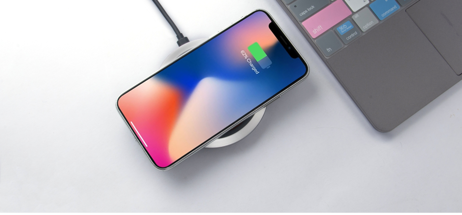 one of the business trip essentials is to prepare complete tech gear, for example on the iPhone 14 pro max gray color which is being charged using a wireless power bank