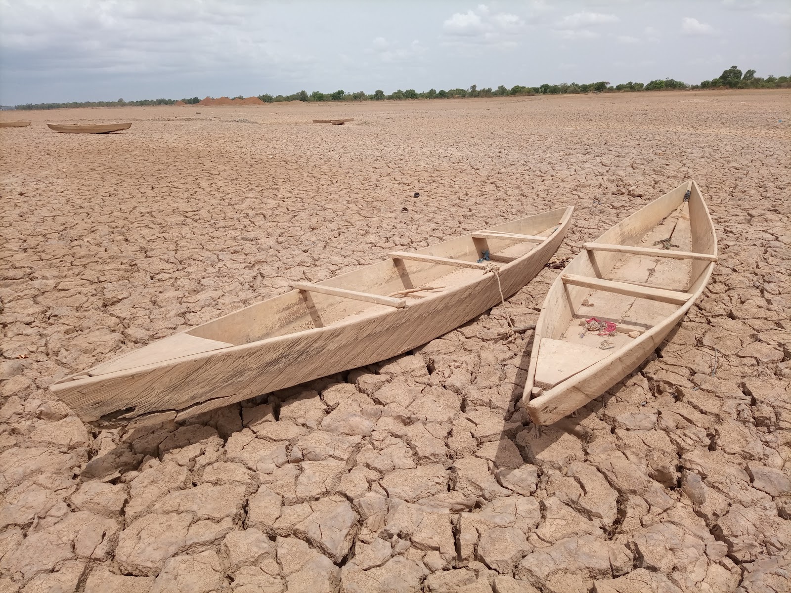 Two abandoned boats on a dried up lake.