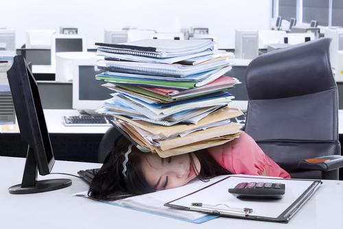 A person sleeping on a desk with a stack of books

Description automatically generated with low confidence