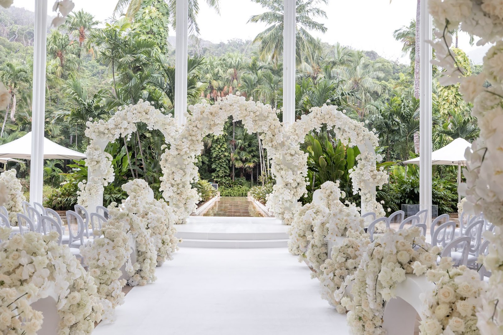 Diane Khoury uses white florals to bring this wedding ceremony venue to life.