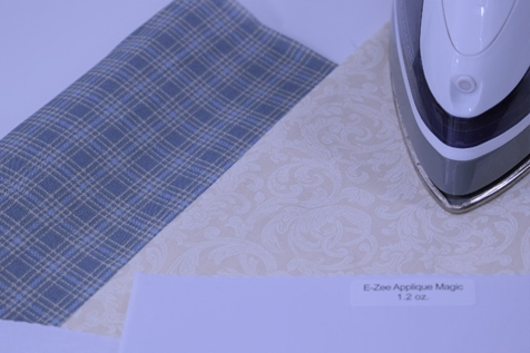 Appliqué fabric, backing and iron. A household iron or heat press can be used for this process. Appliqué fabric, backing and iron.