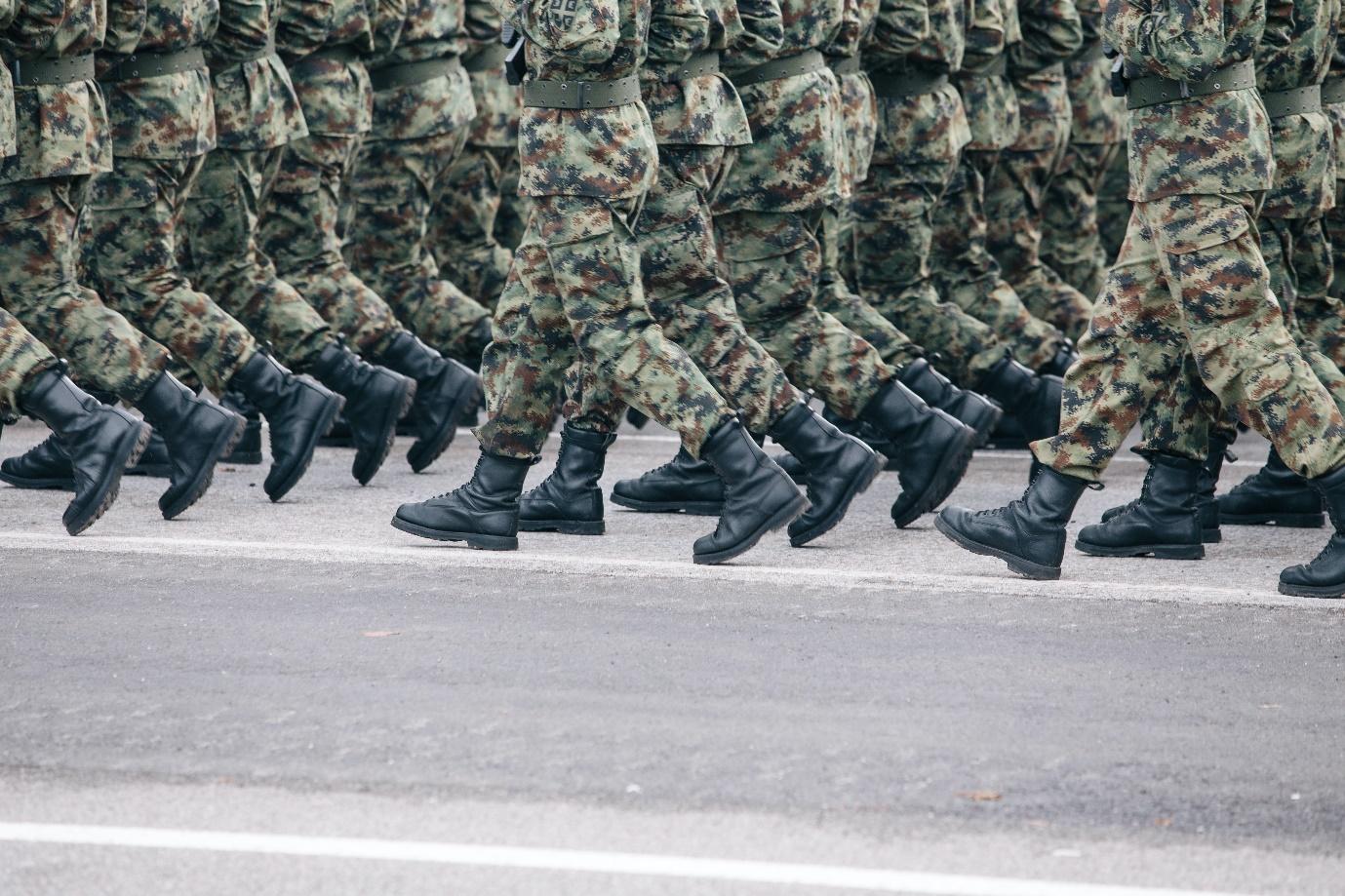 A group of soldiers marching in a line

Description automatically generated