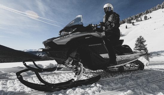 Person on black snowmobile