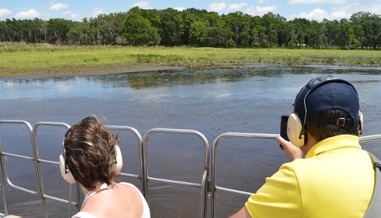 A couple enjoy the views of the Everglades on an airboat tour at Wild Florida