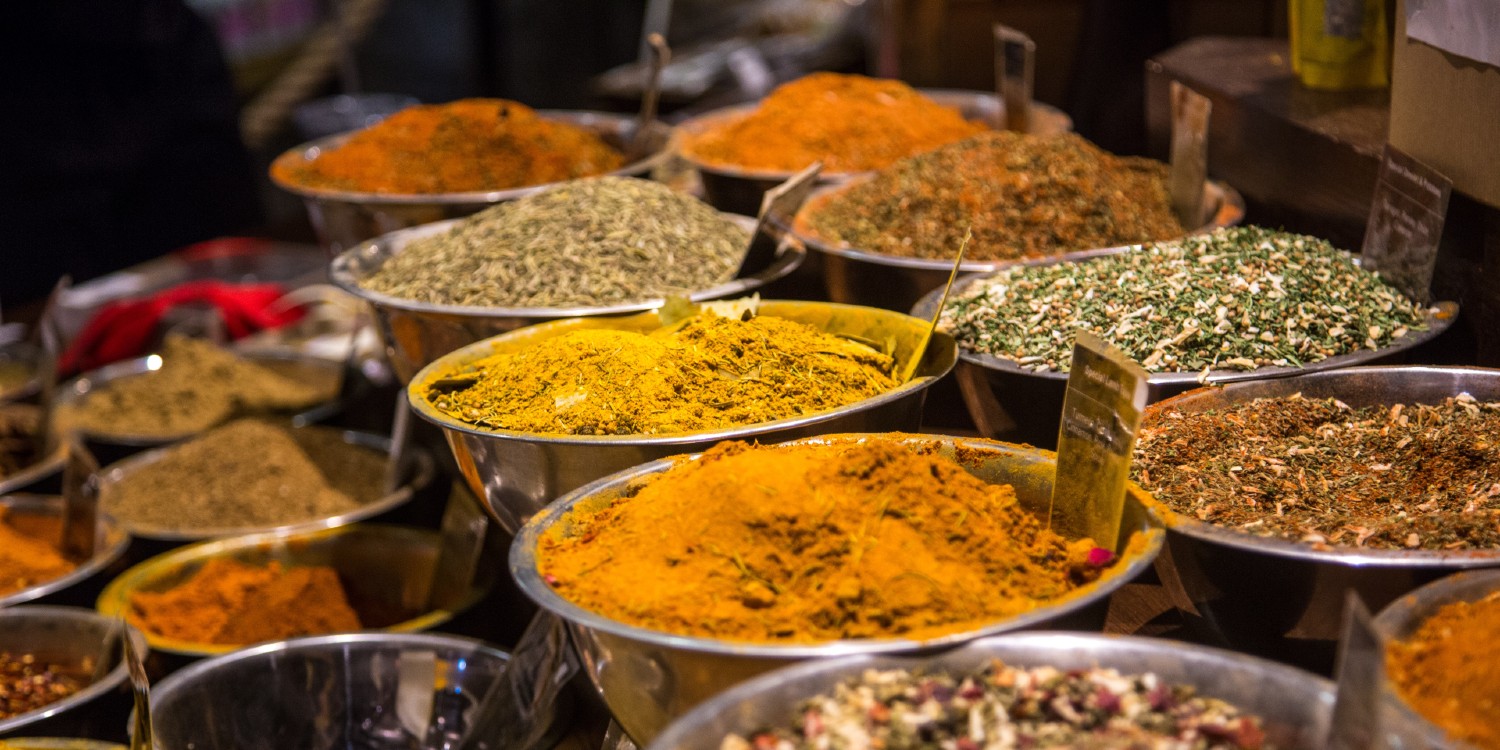 colourful ground spices on display in a market