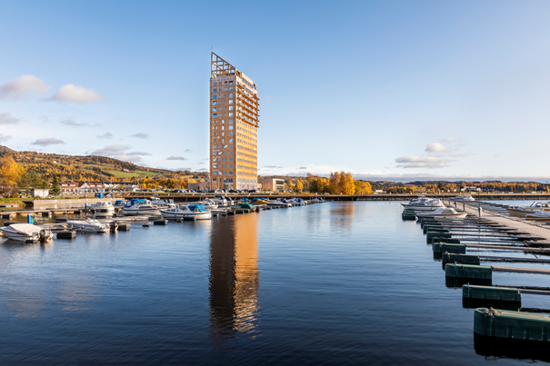 A body of water with boats and a tall building in the background

Description automatically generated with medium confidence