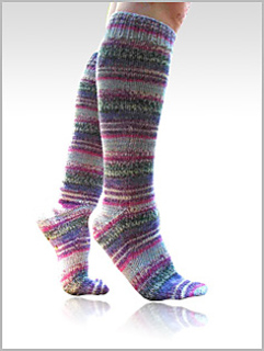 person wearing striped knee high socks on white background