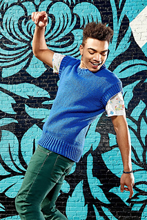 man wearing a blue knitted vest and tee shirt