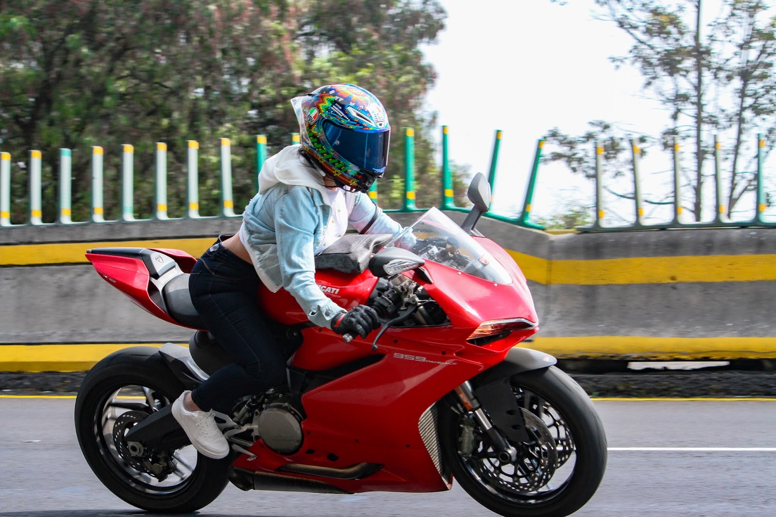 a woman driving a red motorcycle