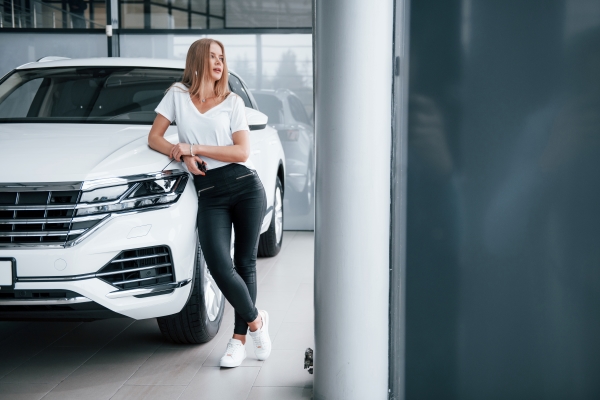 women-beside-car-looking-outside