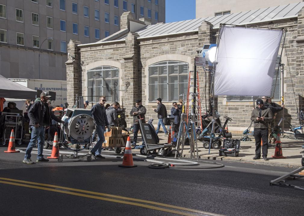 Film crew setting up filming equipment on the sidewalk of NYC