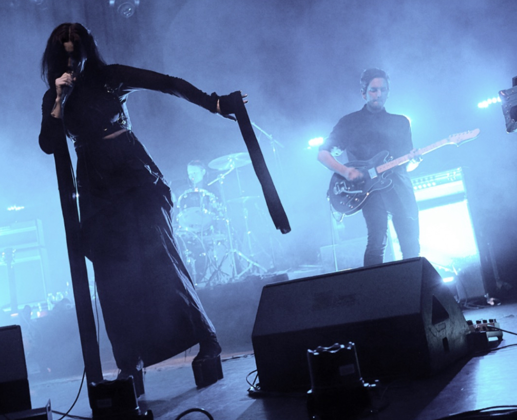 Chelsea Wolfe and band performing onstage during her Hiss Spun tour.