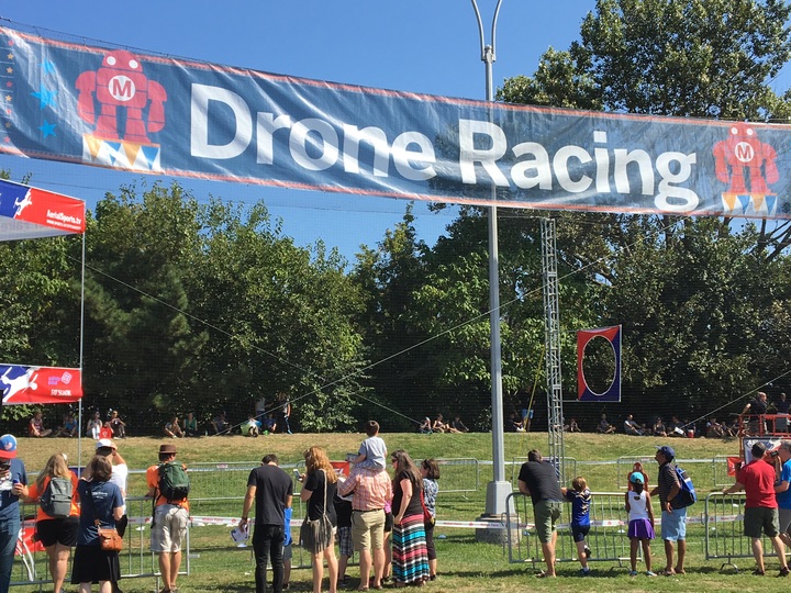 a crowd gathered to watch drone racing at the world maker faire in new york