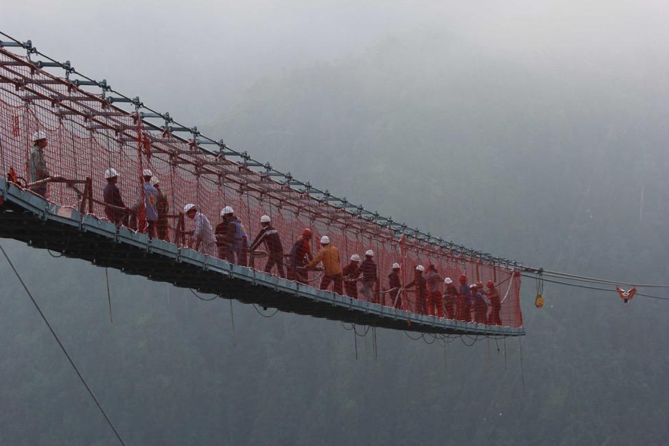 A group of people on a bridge

Description automatically generated with medium confidence