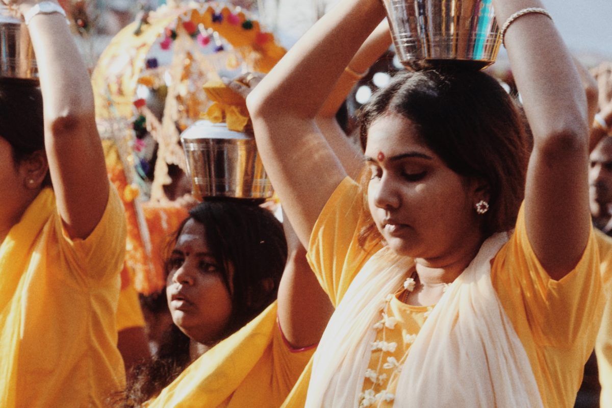 Women at Thaipusam carrying milk atop their heads to symbolize the burdens they carry for themselves and their familes