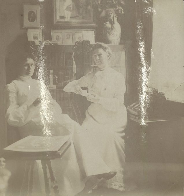 Black and white photograph of two women sitting in a study