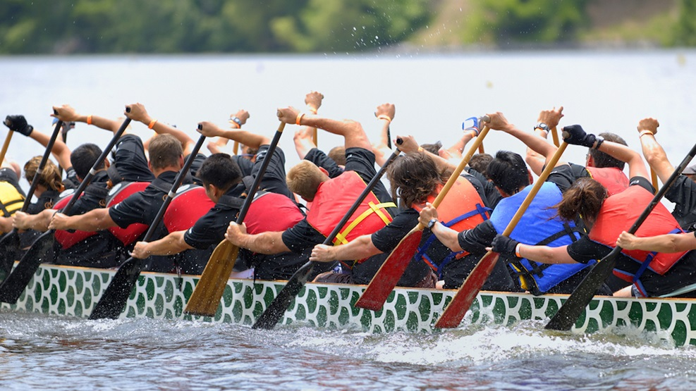people rowing in a dragon boat racing