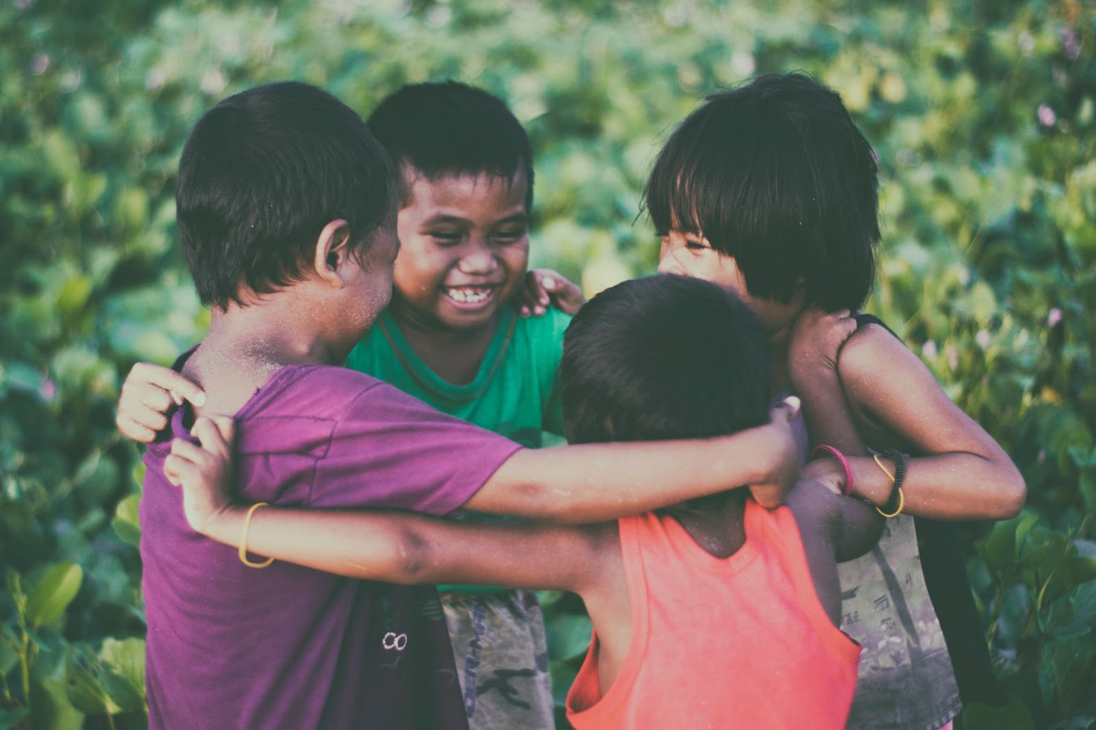 a group of children hugging