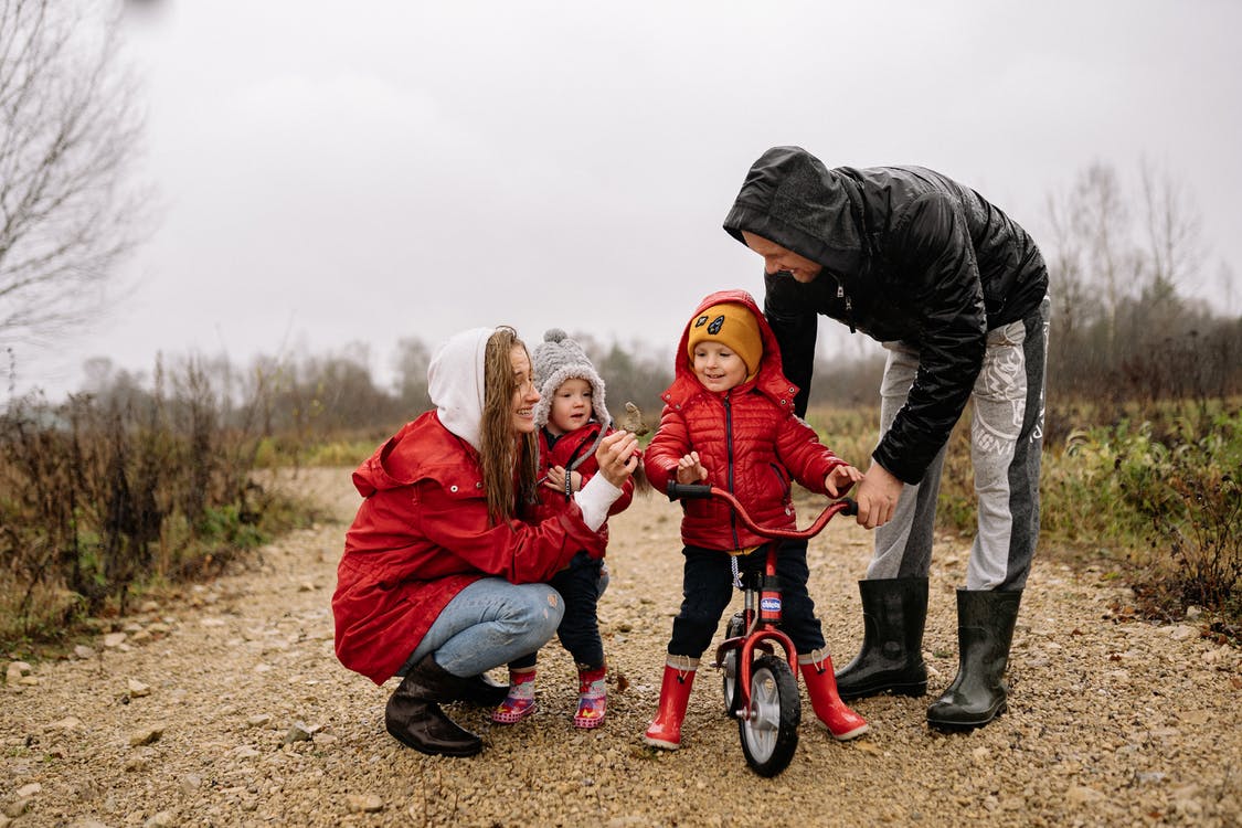Free Woman in Black Jacket and Red Pants Riding on Bicycle With Girl in Red Jacket during Stock Photo