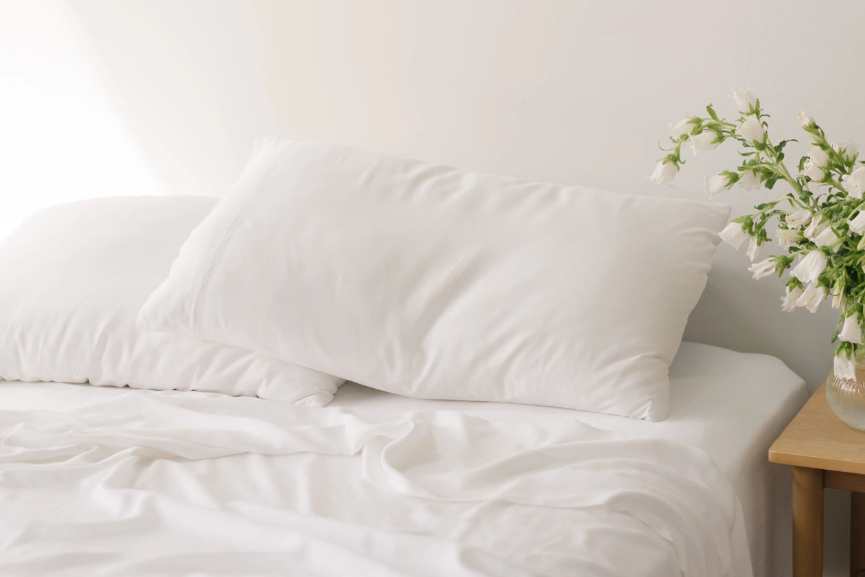 Bed with white sheets and pillowcases