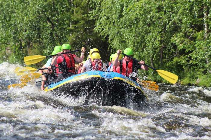 An image of white water rafting as part of a group travel holiday
