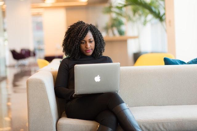 Woman sitting on the couch with a laptop