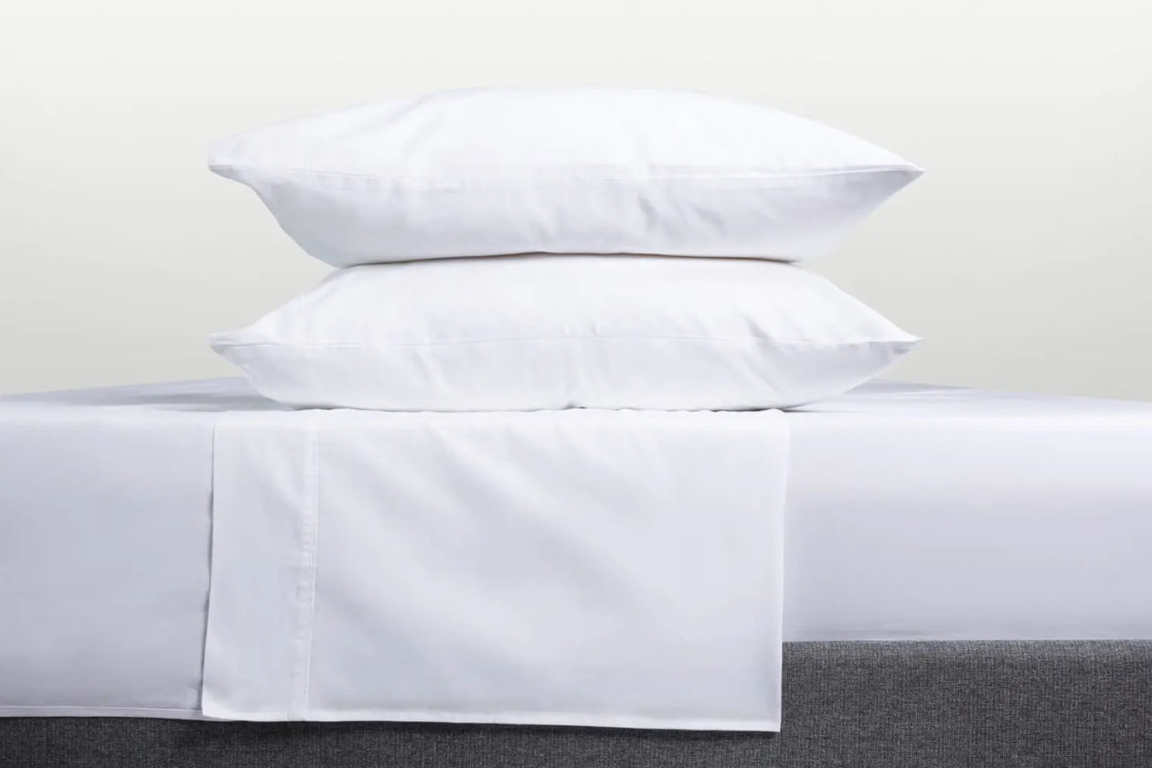 White sheets and pillowcases on bed