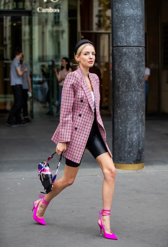 a woman wearing a pink striped blazer with pink shoes